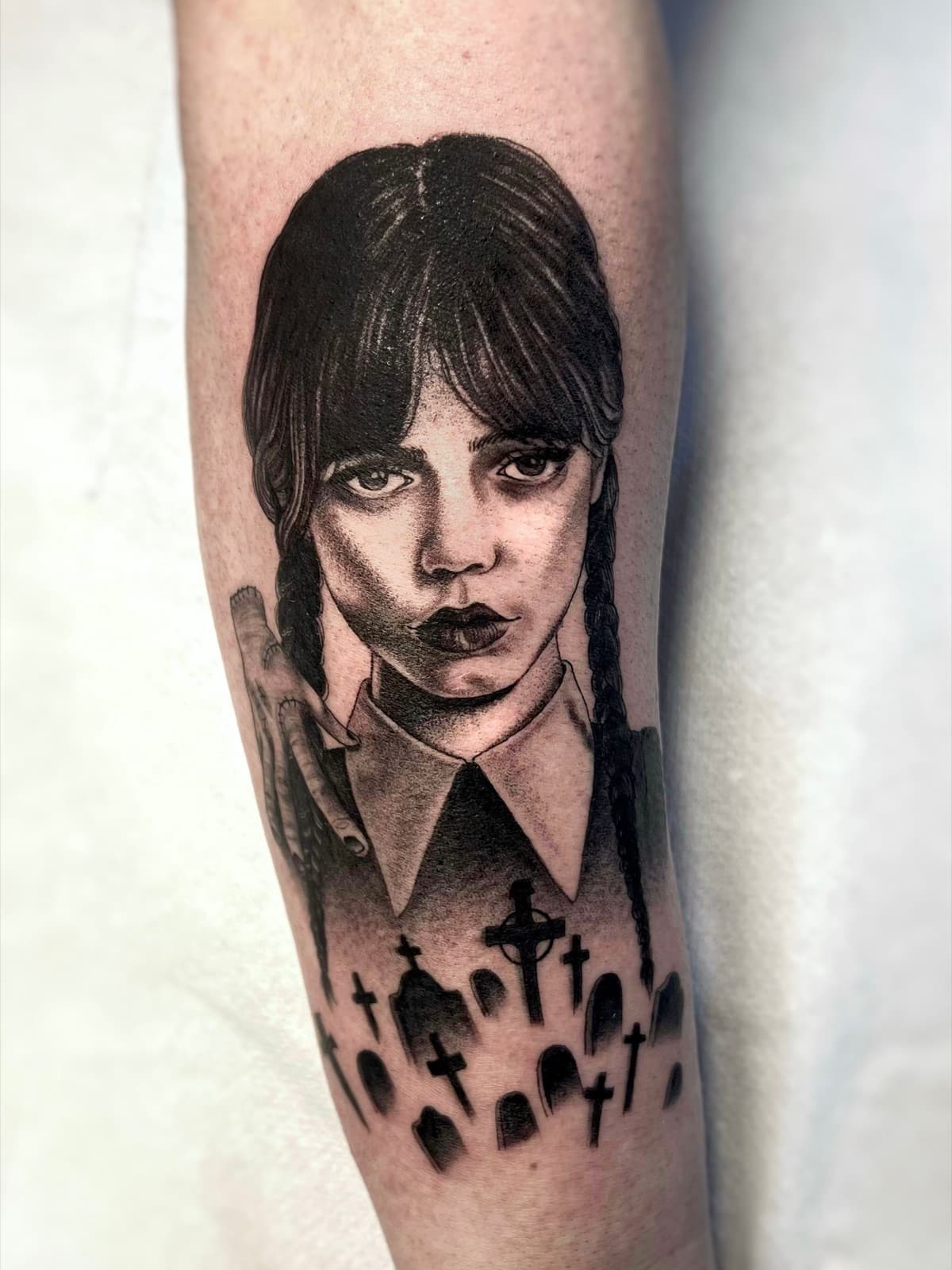 Black and grey Wednesday Addams portrait with graveyard, forearm