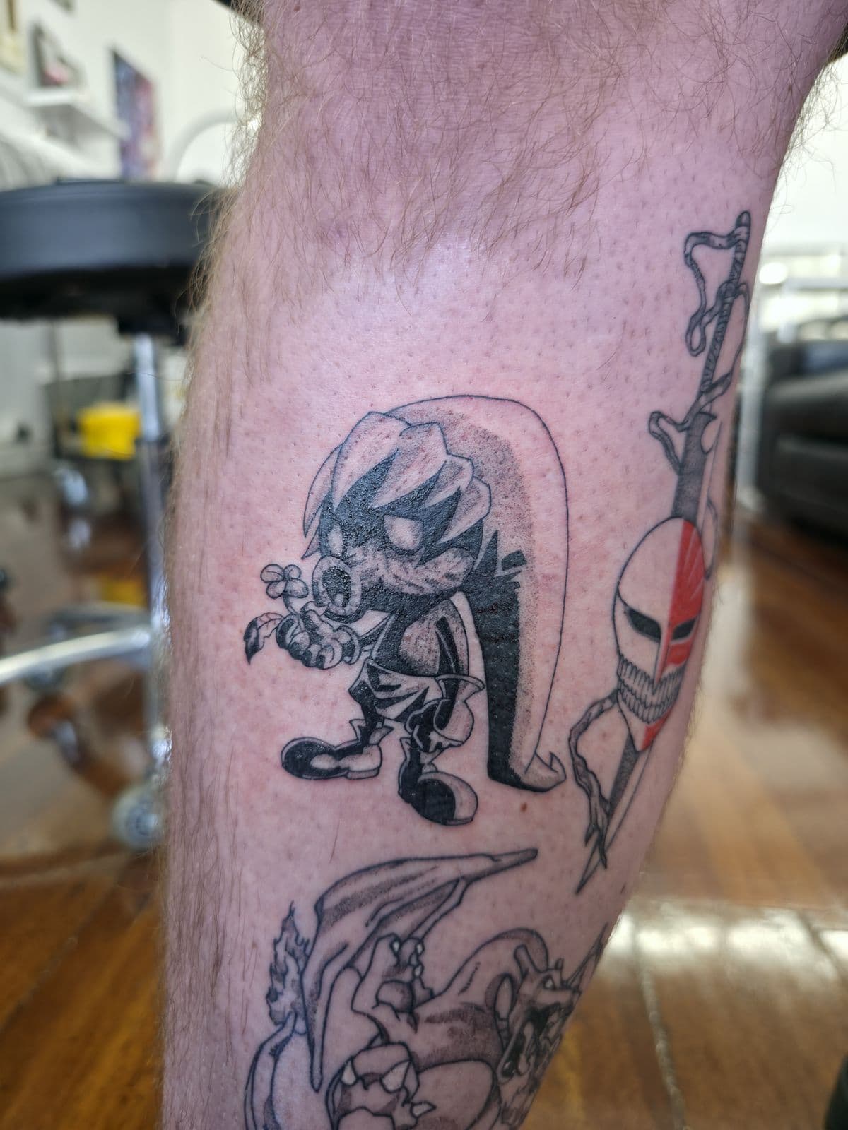 Anime characters in black linework, upper arm