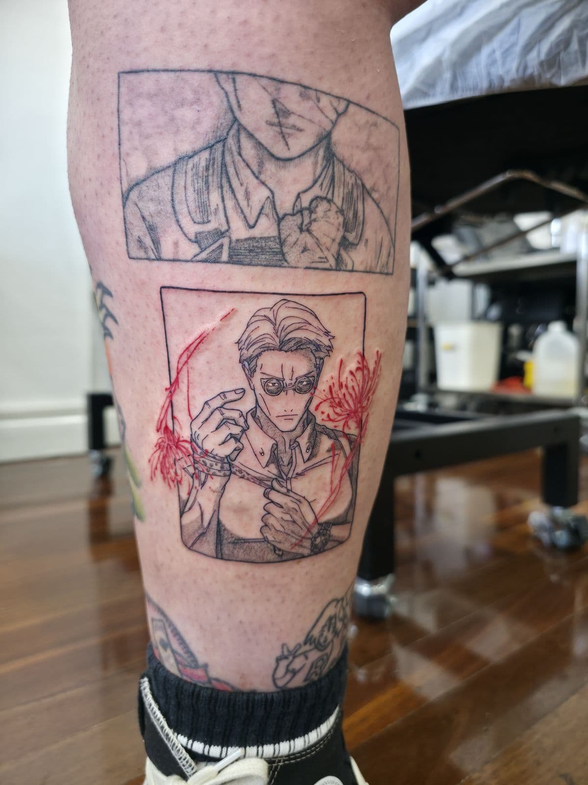 Two manga panels in black linework with red accents, calf