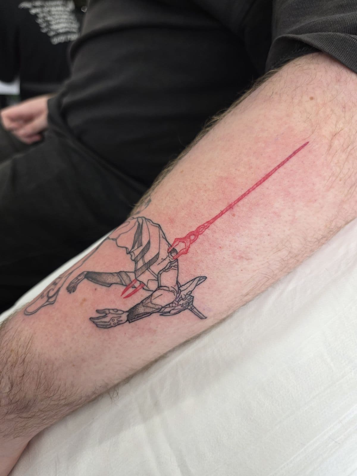 Anime figure with a red lightsaber, forearm