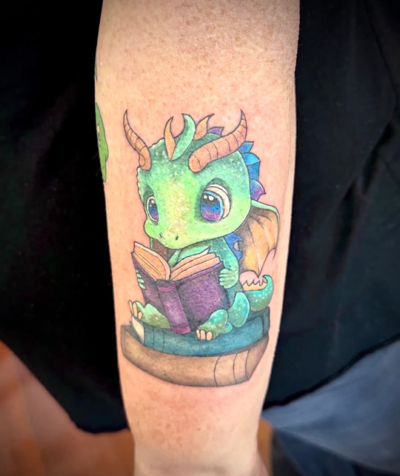 Colour baby dragon reading a book
