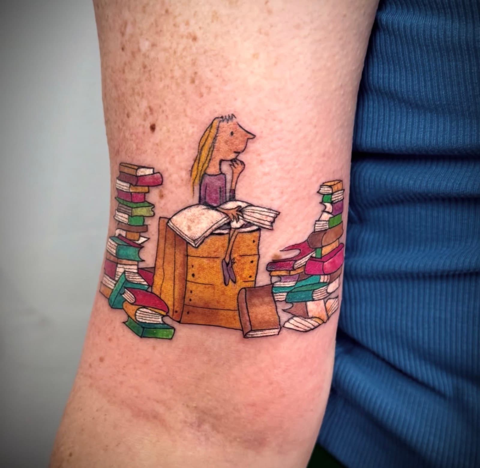 Matilda surrounded by stacks of books, colour illustration style