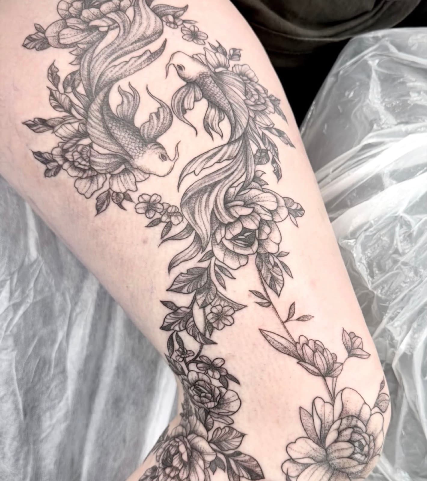 Black and grey koi fish and floral leg piece