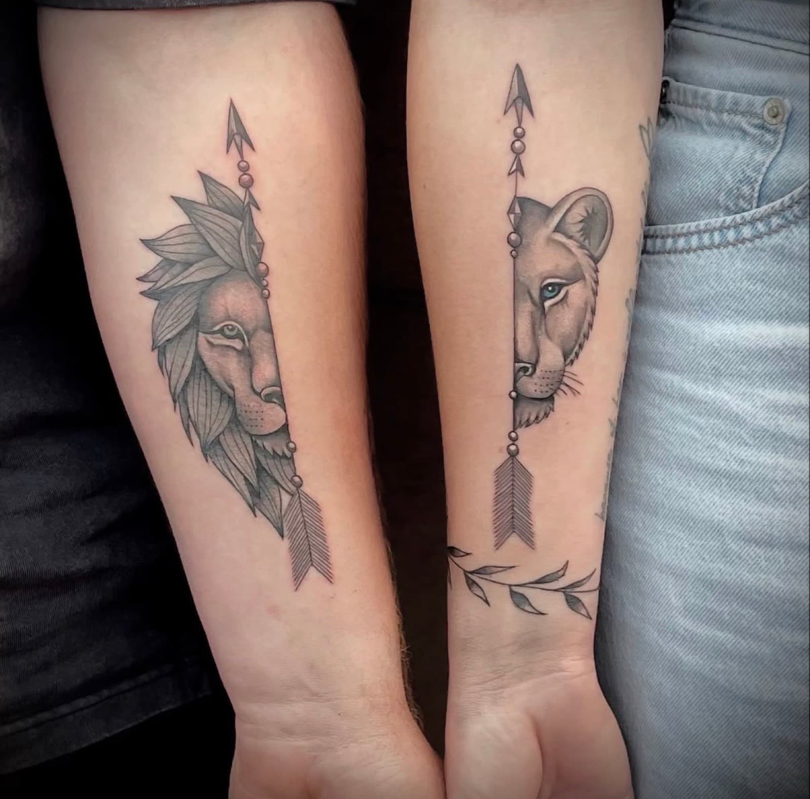 Matching lion and lioness arrow forearm tattoos
