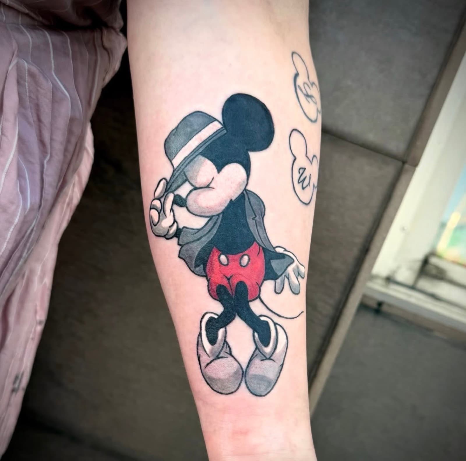Mickey Mouse tipping his hat, colour forearm tattoo